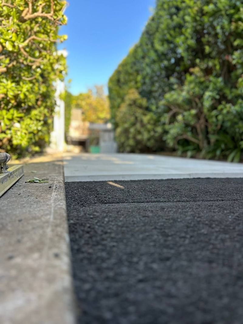 Close-up of screeded bedding layer meeting freshly laid pavers