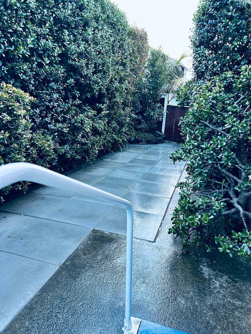 Finished paved courtyard between clipped hedges